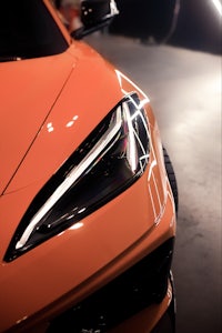 a close up of an orange sports car