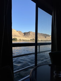 a view of a mountain from the window of a boat