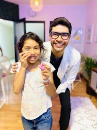 a man and a little girl smiling in a living room