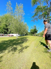 a man is playing golf on a grassy field