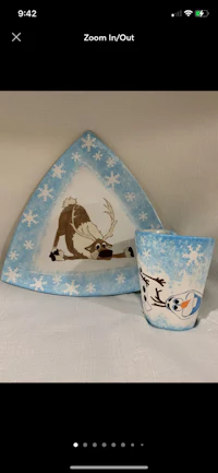 a blue and white plate with a snowman and olaf on it