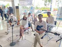 a group of people sitting on chairs in front of a store