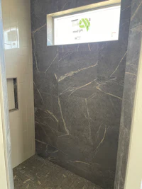 a bathroom with a grey tiled ceiling and a window