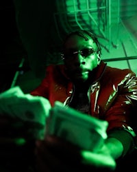 a man in a red jacket holding money in his hands