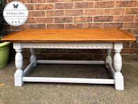 a coffee table with a white top and grey legs