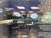 the back cover of a book with a picture of a tattoo shop