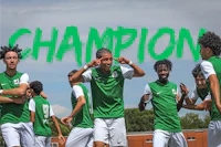 a group of soccer players on a field with the word champion