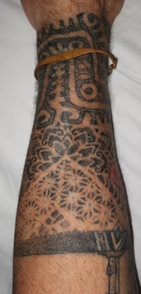 a man with a tattoo on his arm