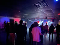 a group of people standing in a dark room