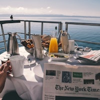 breakfast on a boat with a newspaper on the table