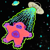 a sticker with a ufo showering a teddy bear