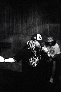 a black and white photo of a man holding a microphone