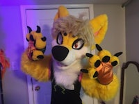 a mascot posing in front of a room