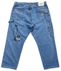 a pair of blue jeans with a drawing on them