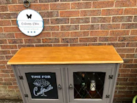 a wooden cabinet with a chalkboard on it