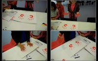 a group of people making handprints on a table
