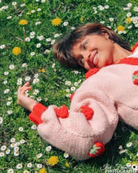 a woman laying down in a field of flowers