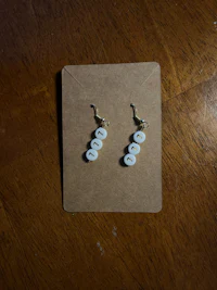 a card with a pair of earrings on it