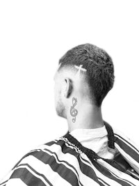 a man with a cross tattoo on his back