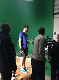 a man standing in front of a green screen