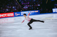 a male figure skater performing in front of an audience