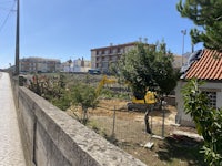 a road next to a building with a construction site in the background