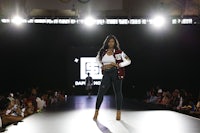 a model walks the runway at the olympic fashion show