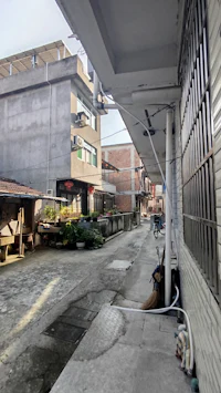 a narrow alley with a building in the background