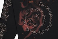 a black long - sleeve t - shirt with writing on it