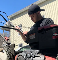 a man working on a lawn mower