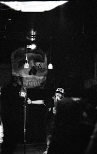 a black and white photo of a group of people in a dark room
