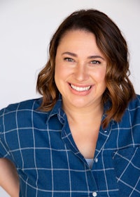 a smiling woman in a blue shirt