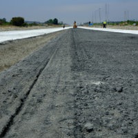 a dirt road in the middle of a field