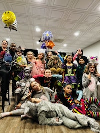 a group of children posing for a photo in a room