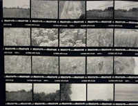 a black and white photograph of a girl in a field
