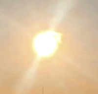 the sun is shining in the sky with a plane in the background