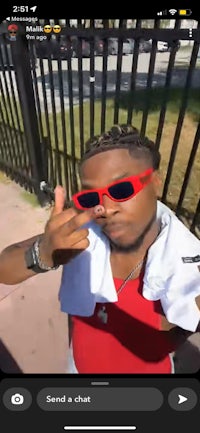 a picture of a man wearing sunglasses and a red shirt