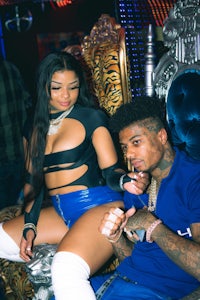 a man and a woman sitting on a throne