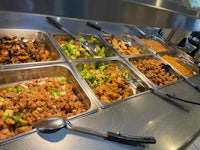 a buffet with a variety of food on trays
