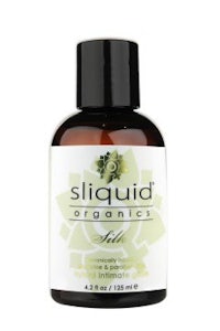 a bottle of sliud organics hair oil on a white background