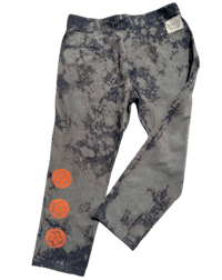 a pair of jeans with orange circles on them