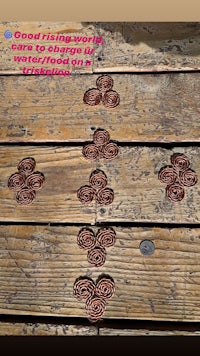 a wooden table with some copper pieces on it