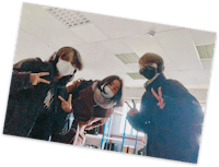 three people wearing face masks posing for a photo