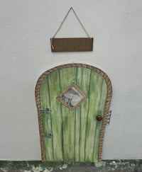 a green door with a sign on it