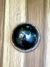 a black and white stone on top of a wooden table