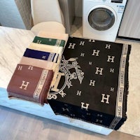 a set of towels and a scarf on top of a washing machine
