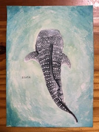 a painting of a whale shark on a wooden table