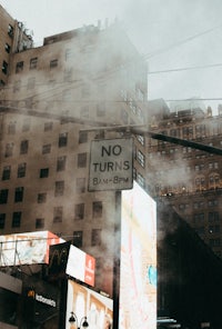 a no turns sign on a street in a city