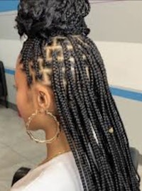 a woman with braided hair in a salon