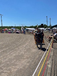 a group of people standing in a dirt field